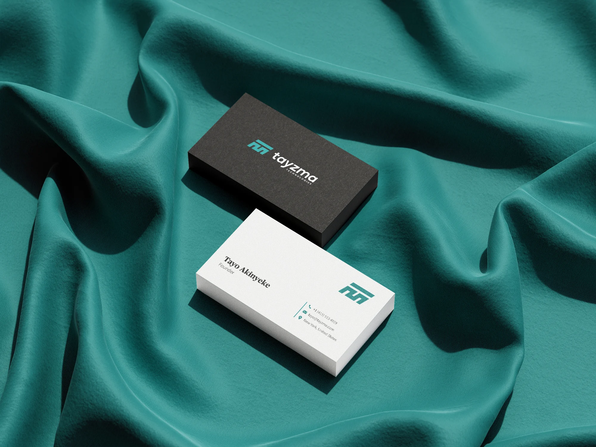 Tayzma business cards in teal and black